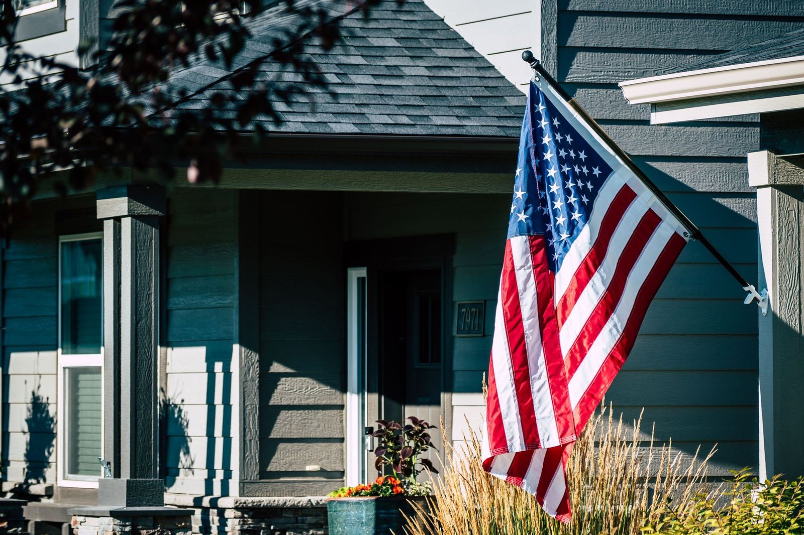 An American flag displayed on a home's front porch